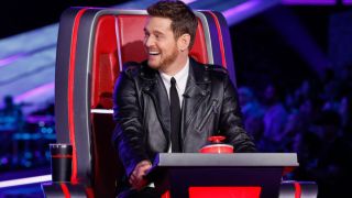 Michael Buble looks at another coach on The Voice Season 26 from his Big Red Chair.