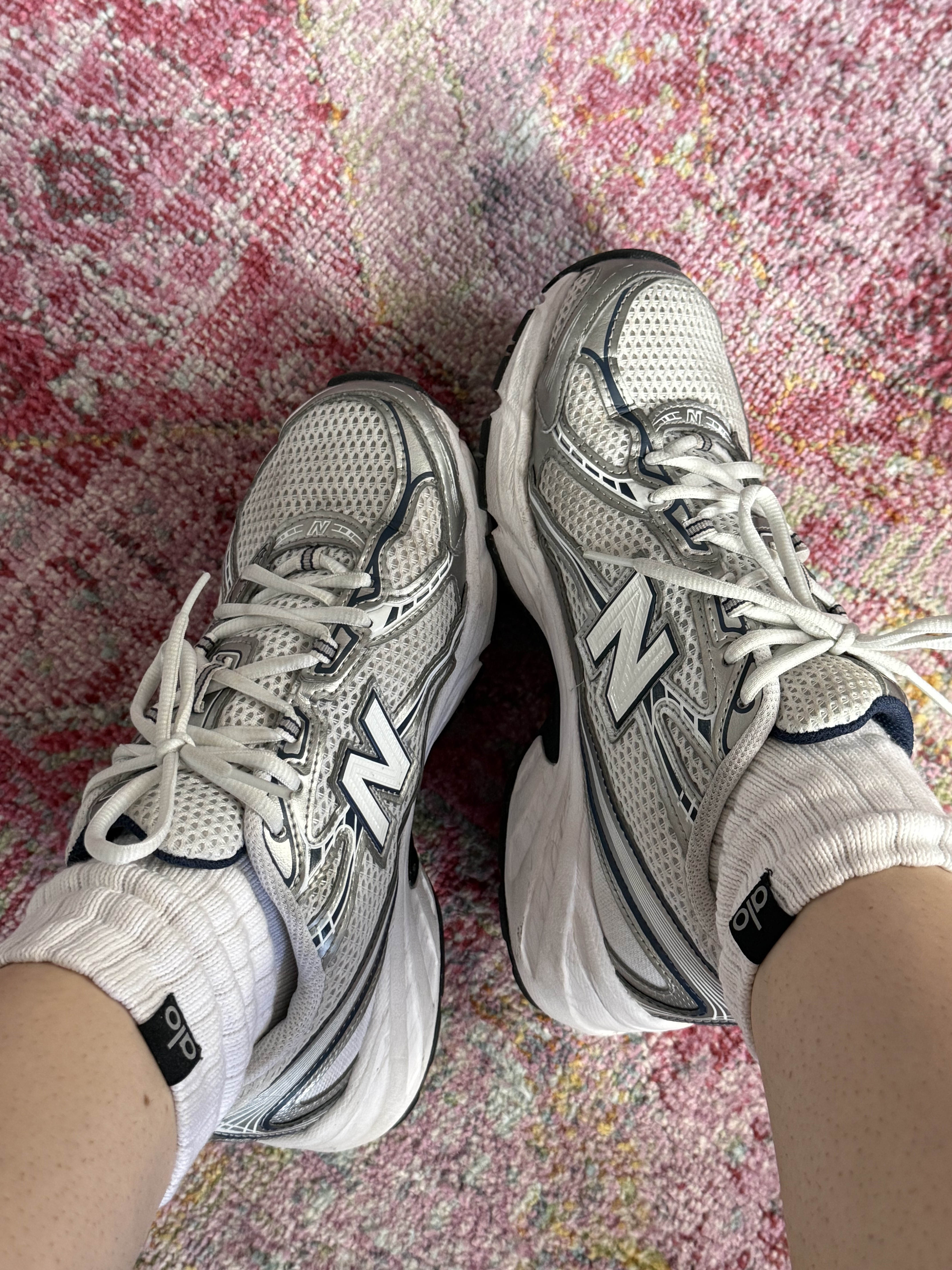 new balance 730 sneakers on pink patterned rug