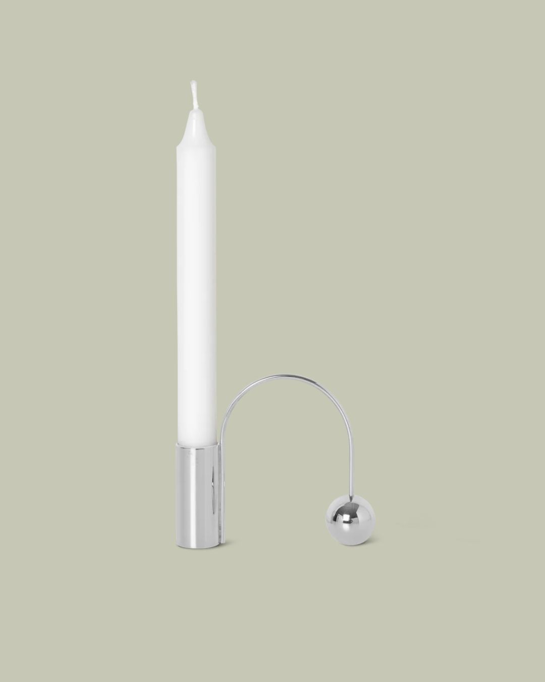 Balance Candle Holder in Chrome against pale green background.