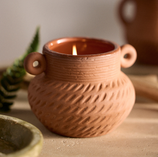 terracotta candle in the shape of a vase