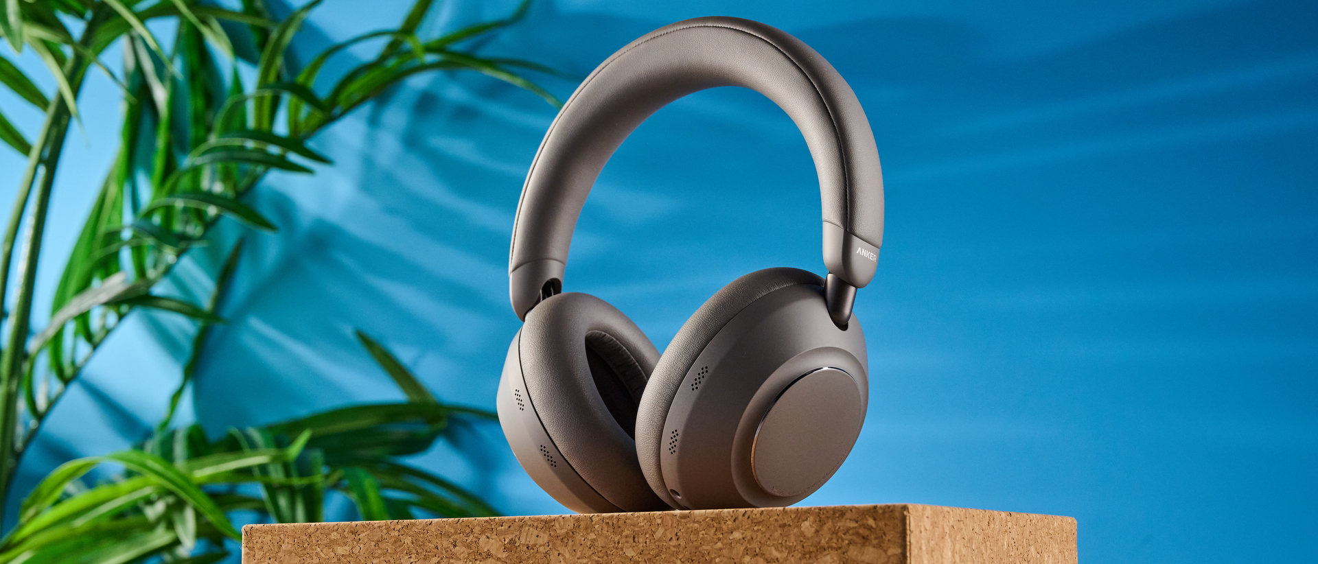 the anker soundcore space 2 pro headphones in mauve gray photographed against a blue tom's guide background
