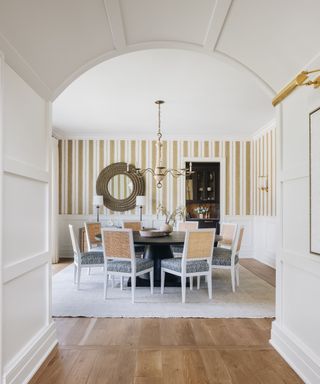 walkway arch to dining room with striped wallcovering