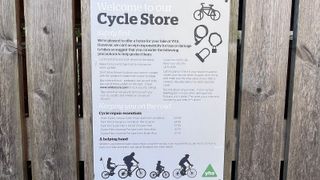 Youth hostel cycle store notice on fence