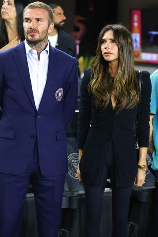 Co-owner David Beckham of Inter Miami CF and wife Victoria Beckham - who wears a black blazer and trouser outfit - look on prior to a game between Charlotte FC and Inter Miami at DRV PNK Stadium on October 18, 2023 in Fort Lauderdale, Florida.