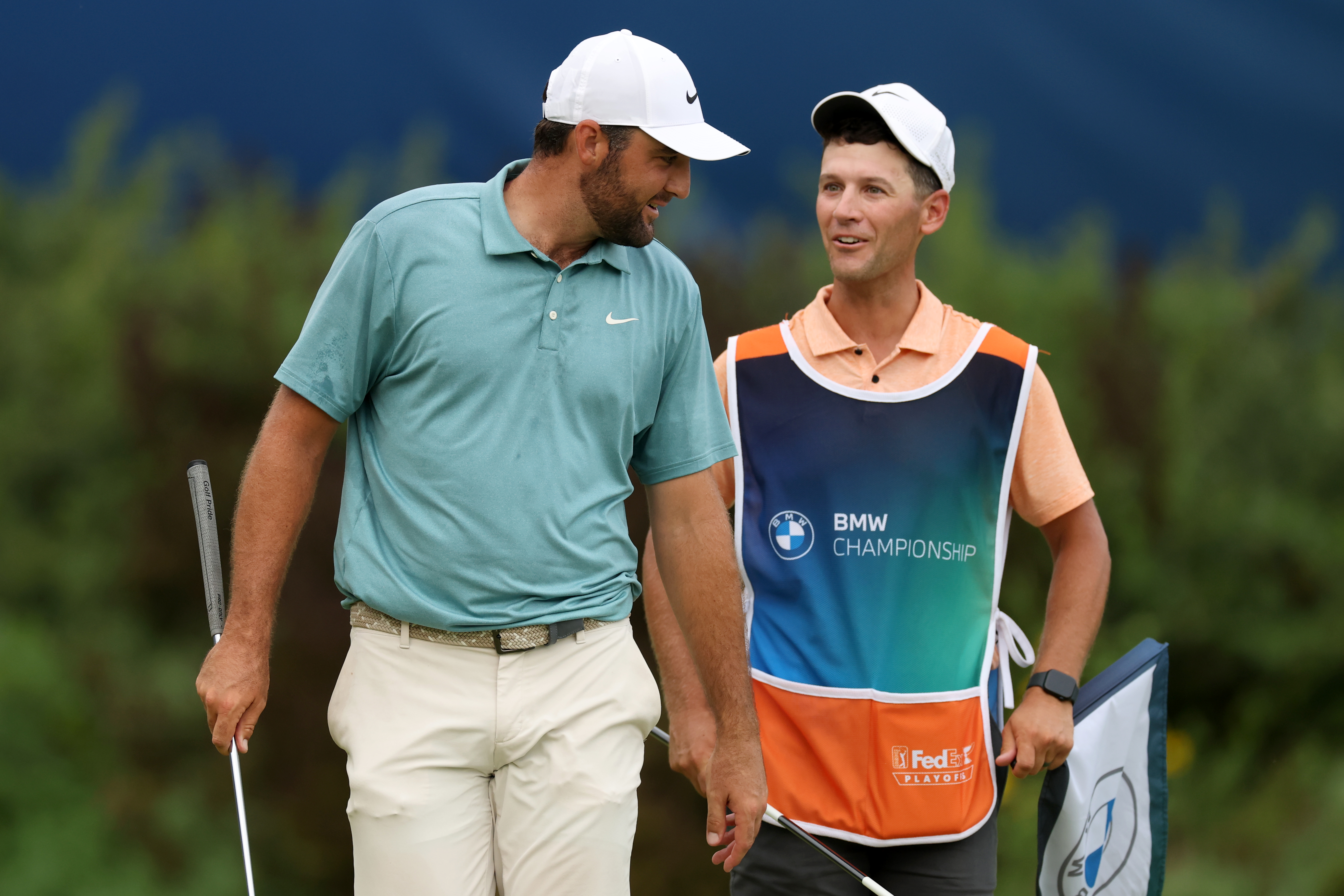 Scottie Scheffler (left) and stand-in caddie, Michael Cromie talk during the 2025 BMW Championship final round