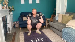 Harry Bullmore performing a thruster while using the Fiit app
