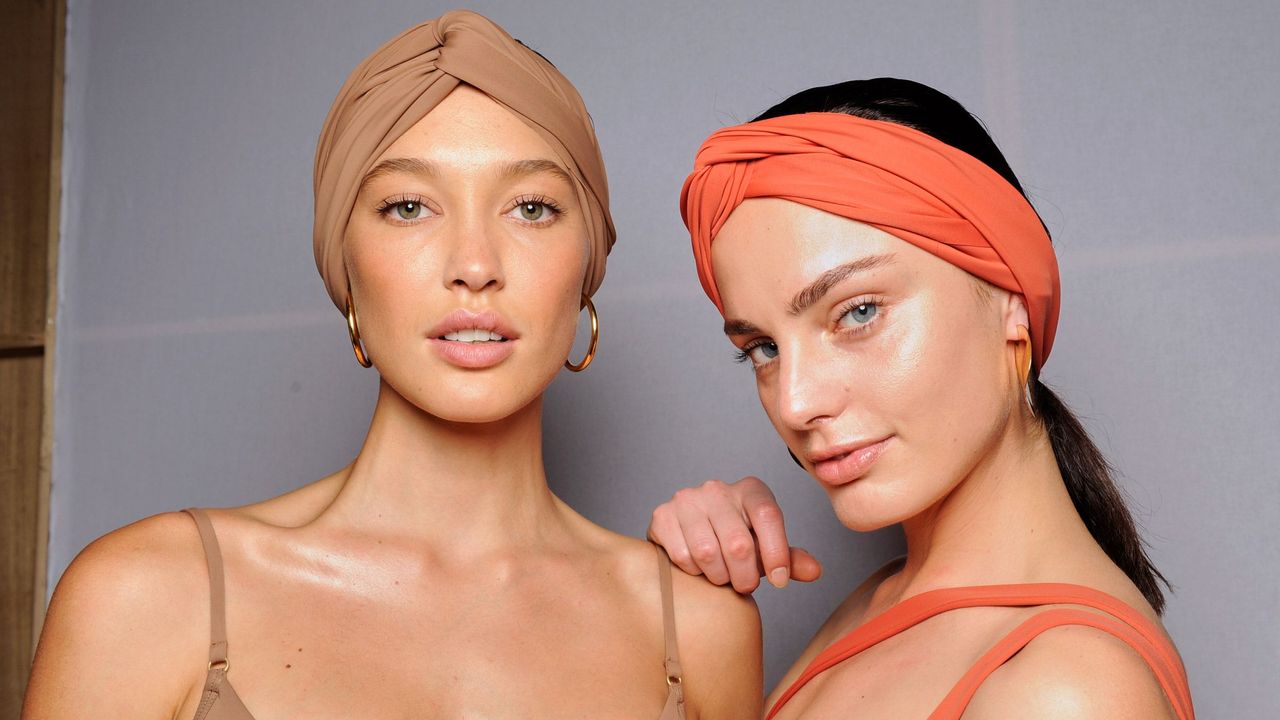 A close-up of two models after applying self-tanner.