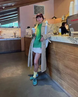 Woman wearing miniskirt with sneakers trend