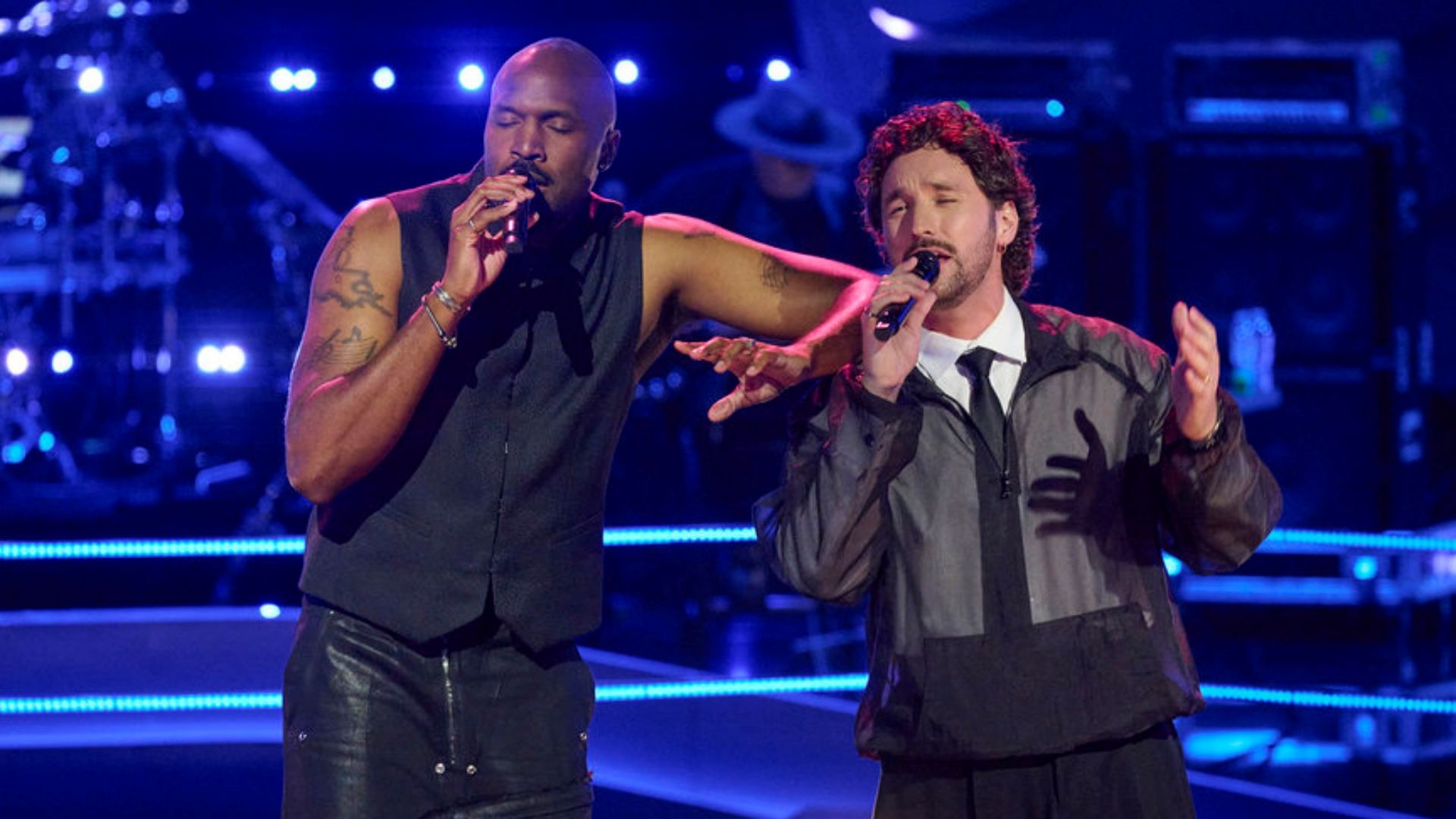 Bryan Jaymes and Brandon Diaz singing together during The Battles in Season 30 of The Voice.