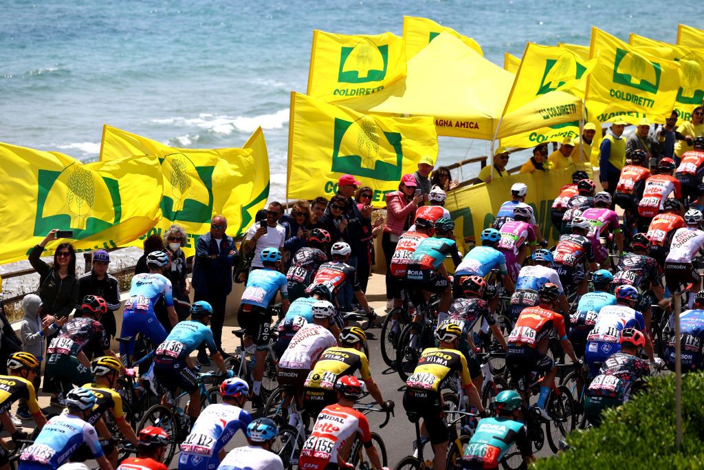ETNA PIAZZALE RIFUGIO SAPIENZA ITALY MAY 10 A general view of the peloton competing next to the seaside while fans cheer during the 105th Giro dItalia 2022 Stage 4 a 172km stage from Avola to Etna Piazzale Rifugio Sapienza 1899m Giro WorldTour on May 10 2022 in Etna Piazzale Rifugio Sapienza Italy Photo by Michael SteeleGetty Images