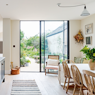 glass patio doors into kitchen with traditional table and chairs