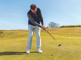 John Jacobs demonstrating the appropriate follow-through length with the putter