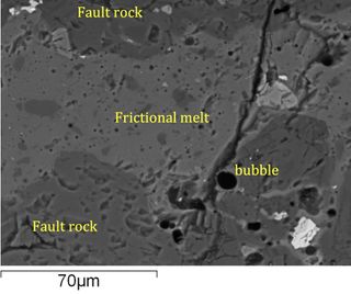 Image, obtained by a scanning electron microscope, of round bubbles (in black) formed in a rock that was heated and melted during a friction experiment.