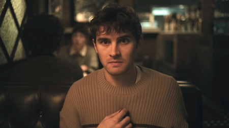 Michael Johnson as Bear sitting at a restaurant in Obsession 