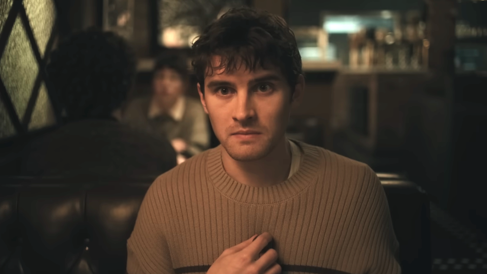 Michael Johnson as Bear sitting at a restaurant in Obsession 