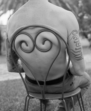 Kent Andreasen photograph of man's back against chair