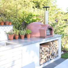outdoor kitchen units with herbs and pizza oven