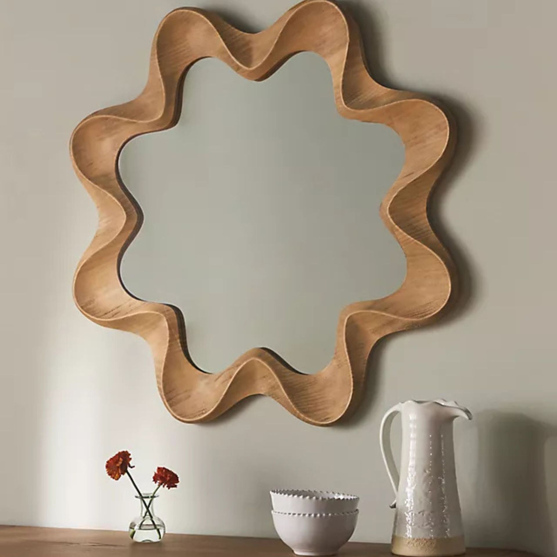 Emerson Wall Mirror on a wall.