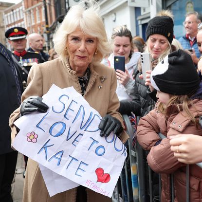 Queen Camilla receives a message of support for Catherine, Princess of Wales from well-wishers during her visit to the Farmers' Market on March 27, 2024 in Shrewsbury, England. 