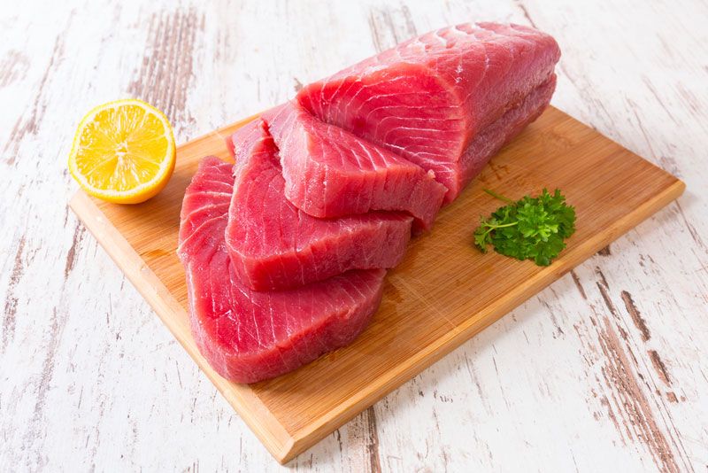 A raw tuna steak on a cutting board