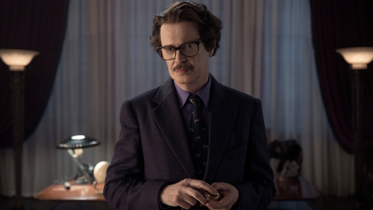 Steve Buscemi as Barry Dort holding something in his hands in Wednesday.