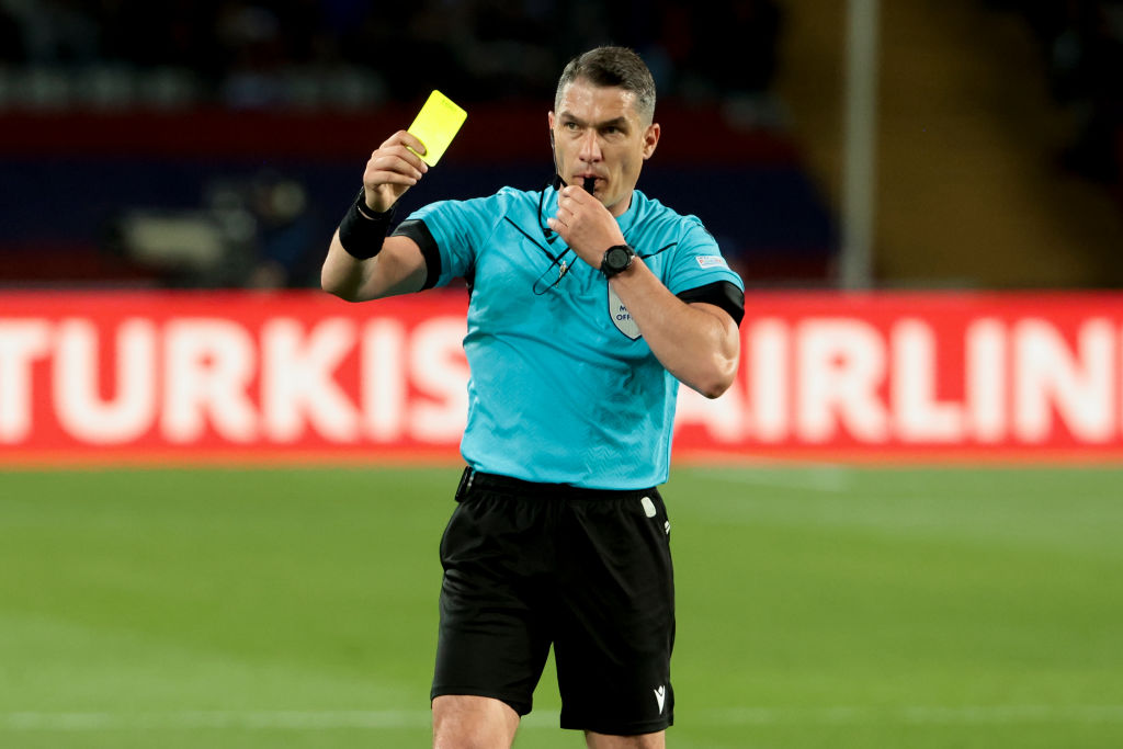 Referee Istvan Kovacs of Romania gives a yellow card to Raphinha of Barcelona during the UEFA Champions League quarter-final second leg match between FC Barcelona (Barca) and Paris Saint-Germain (PSG) at Estadi Olimpic Lluis Companys on April 16, 2024 in Barcelona, Spain.(Photo by Jean Catuffe/Getty Images)