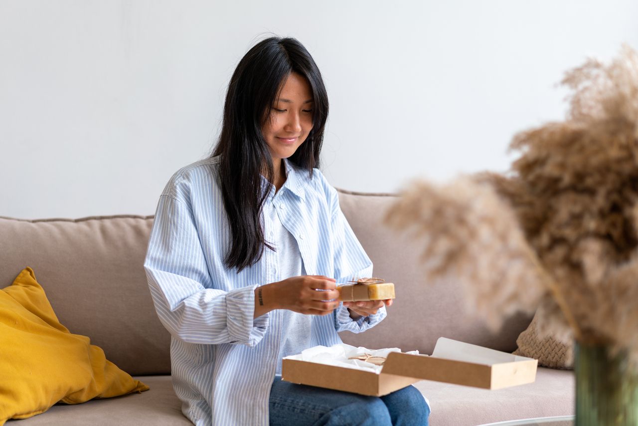 Woman opening a beauty subscription box