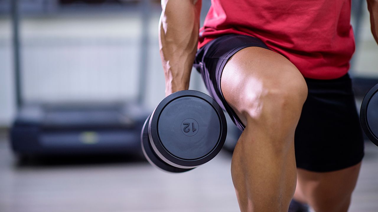 Man doing a dumbbell lunge