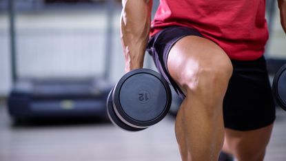 Man doing a dumbbell lunge