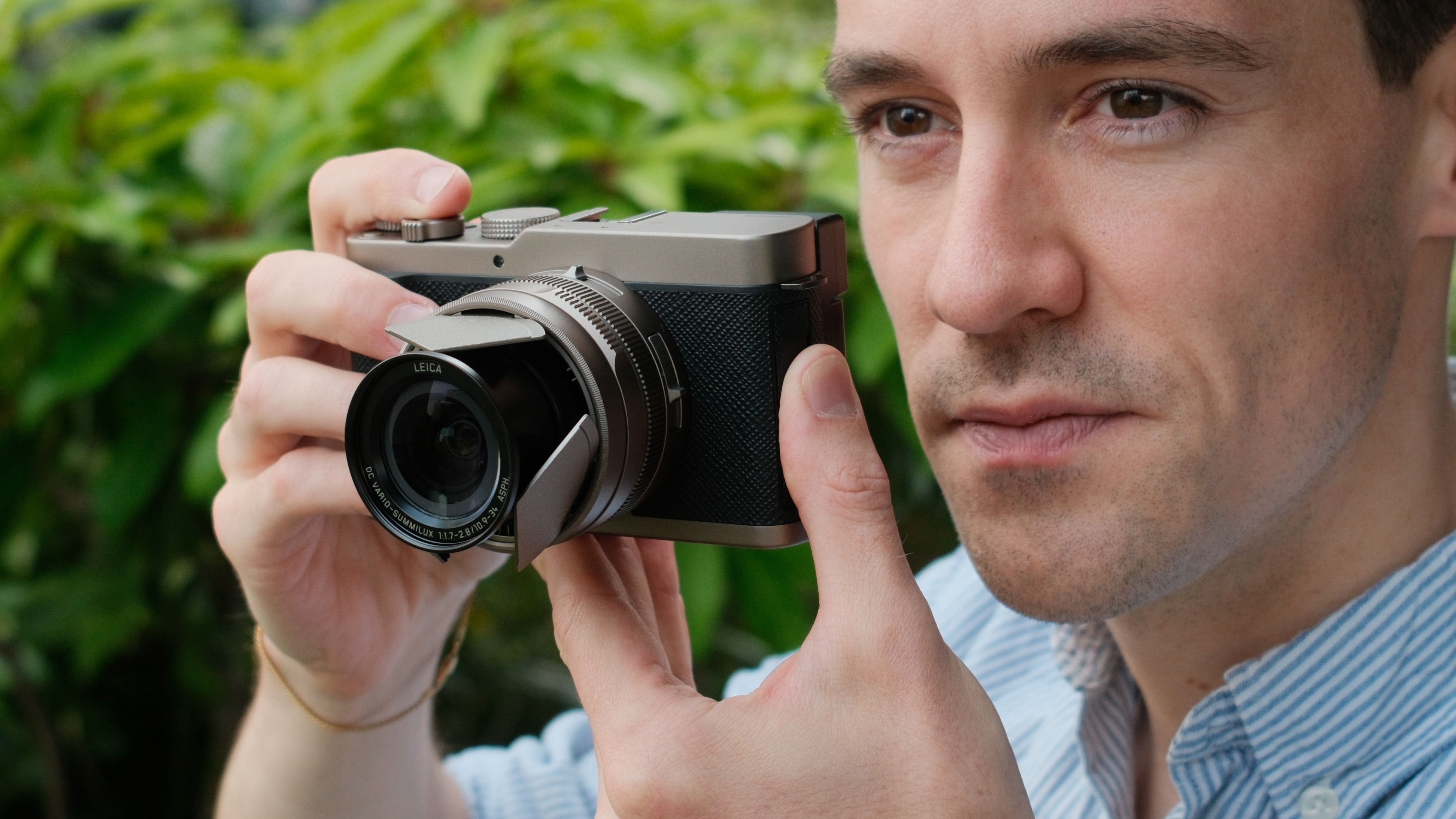 Person holding the Panasonic Lumix L10 camera up to their eye.
