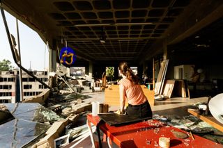 A woman sitting on rubble