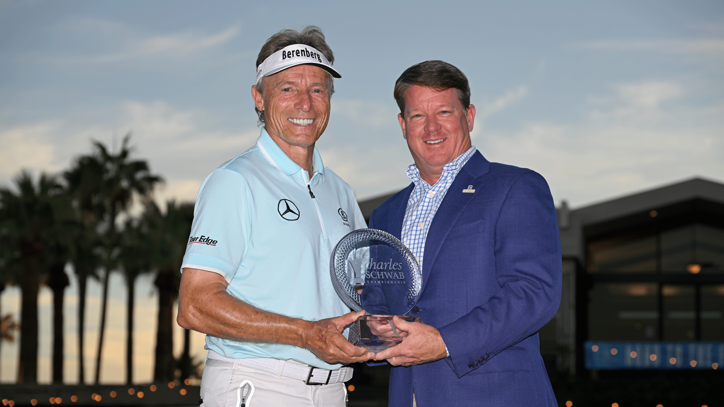 Bernhard Langer and Miller Brady pose with the Charles Schwab Cup Championship trophy in 2024