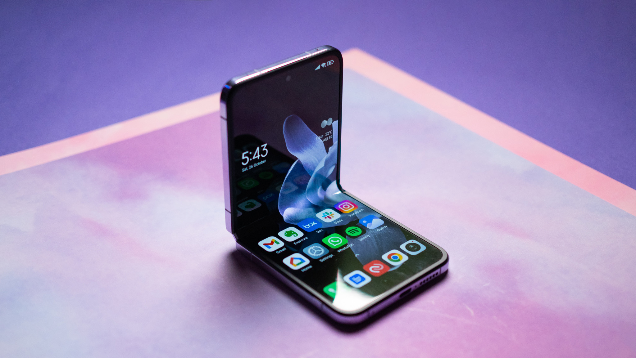 Xiaomi Mix Flip half folded against a purple background