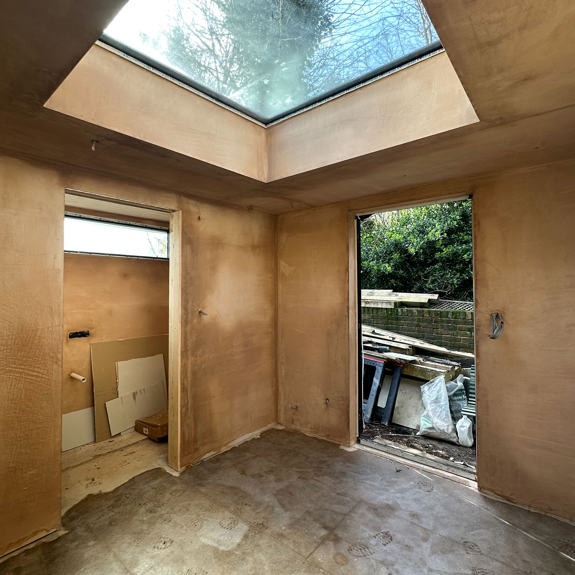 Interior of newly built space with bare surfaces and skylight