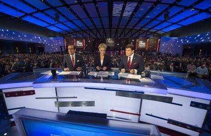 Fox News hosts look on during the Republican Presidential debate sponsored by Fox News at the Iowa Events Center in Des Moines, Iowa on January 28, 2016. 