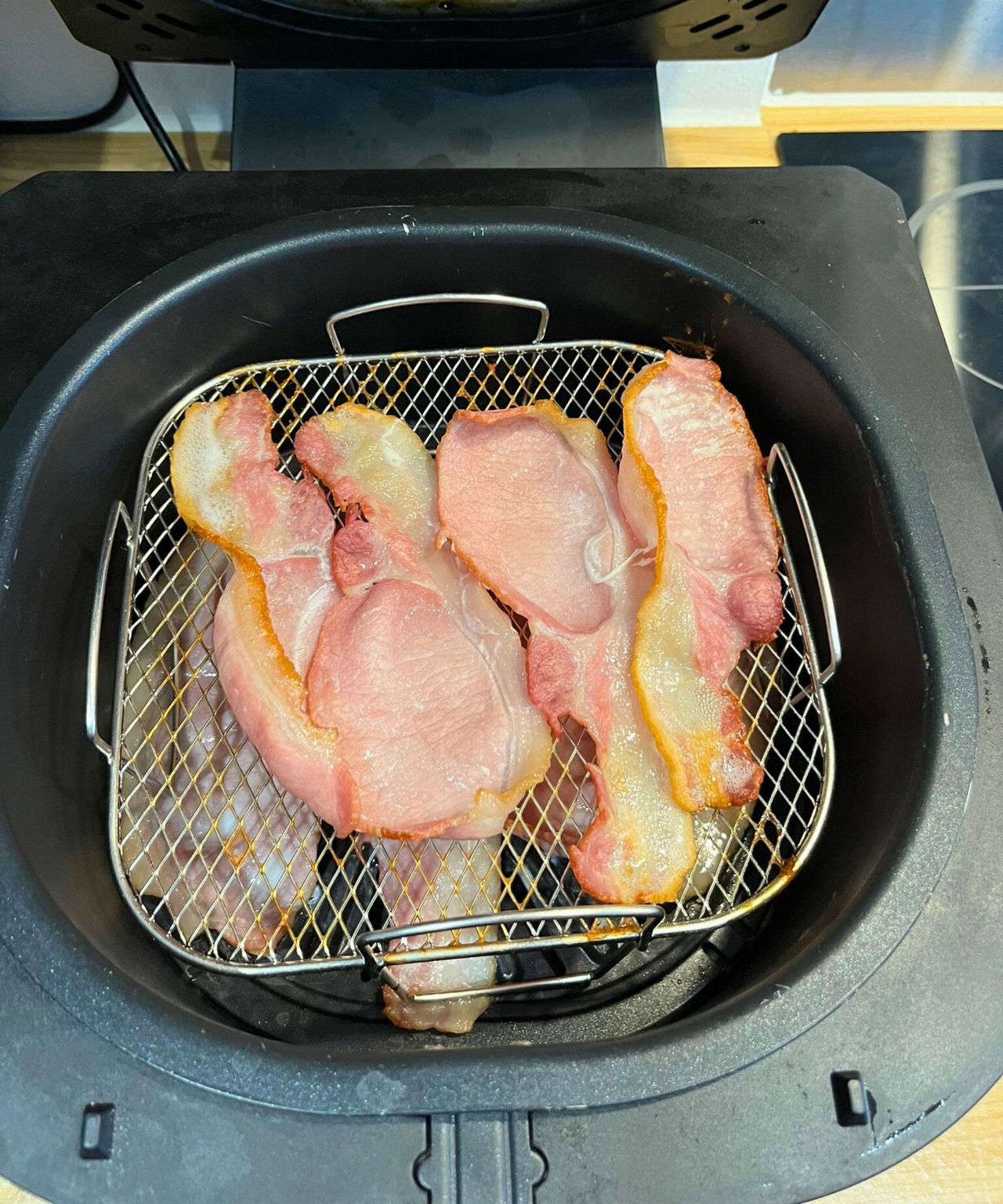 The crispy layer of bacon that cooked underneath the air fryer rack