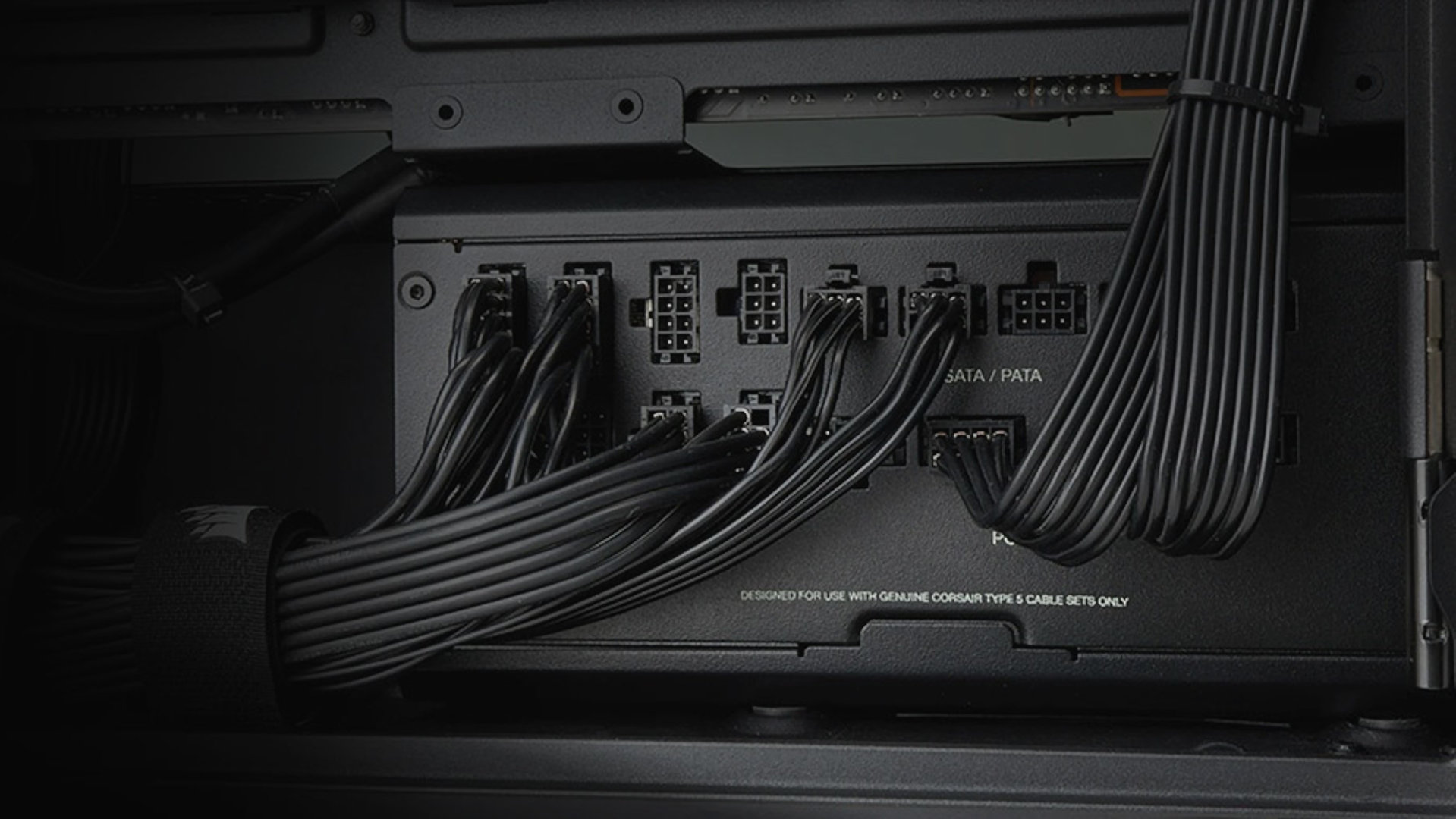 A promotional image for a Corsair RMx Shift PSU, showing how the repositioning of the power connectors makes it easier to route the cables in the PC case.