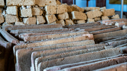 A detail of the neatly aligned ceramic roof tiles and tuff blocks in a newly excavated site in Pompeii.