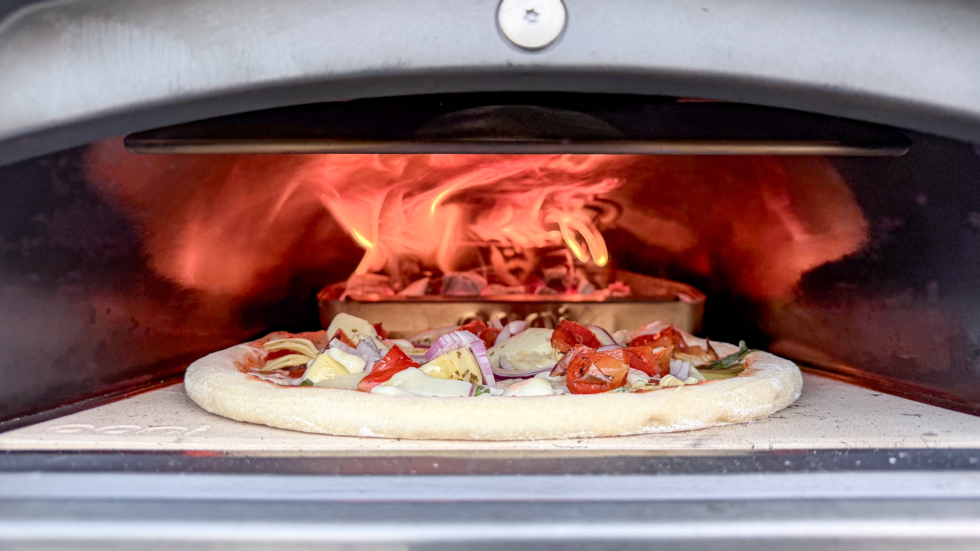 A pizza being cooked inside the Ooni Karu 2 pizza oven