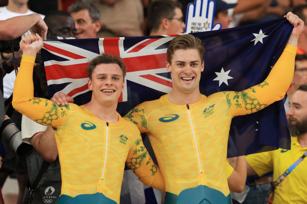 Australia's Matthew Richardson and Australia's Matthew Glaetzer celebrate their second and third place in the men's track cycling keirin final for gold of the Paris 2024 Olympic Games at the Saint-Quentin-en-Yvelines National Velodrome in Montigny-le-Bretonneux, south-west of Paris, on August 11, 2024. (Photo by Emmanuel DUNAND / AFP)