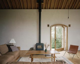 Living space with large pivoting window at Redhill Barn in the UK