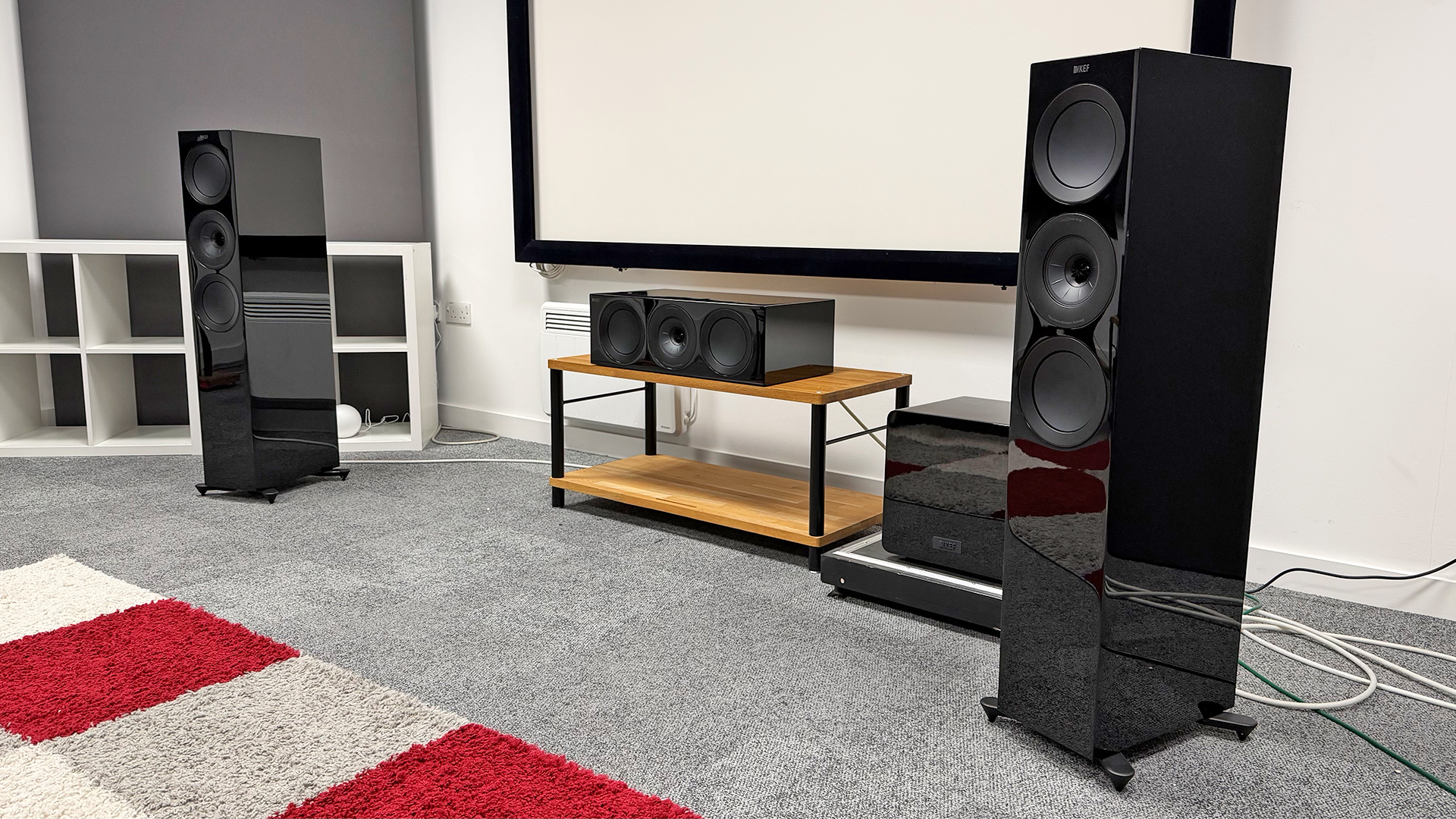 KEF R Meta 5.1 Speaker System speaker package floorstanding, centre and sub speakers in grey carpeted test room