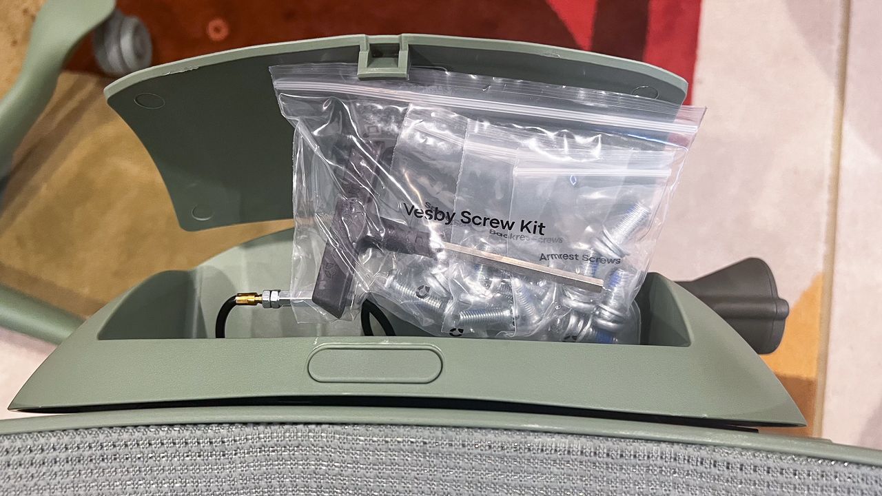 Hatch under the seat of the ErgoTune Vesby office chair holding bags of tools