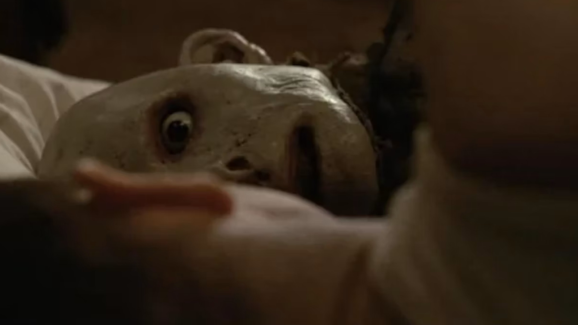 A close-up of a creepy puppet during one of the best scary movies Possum.