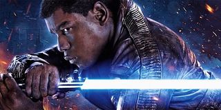 Finn holding a lightsaber in Star Wars: The Force Awakens