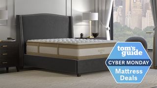 The Saatva RX mattress on a grey bedframe with a blue Cyber Monday mattress deals badge overlaid