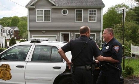 Police officers stand outside Pakistani-born Faisal Shazhad&amp;#039;s Connecticut home.