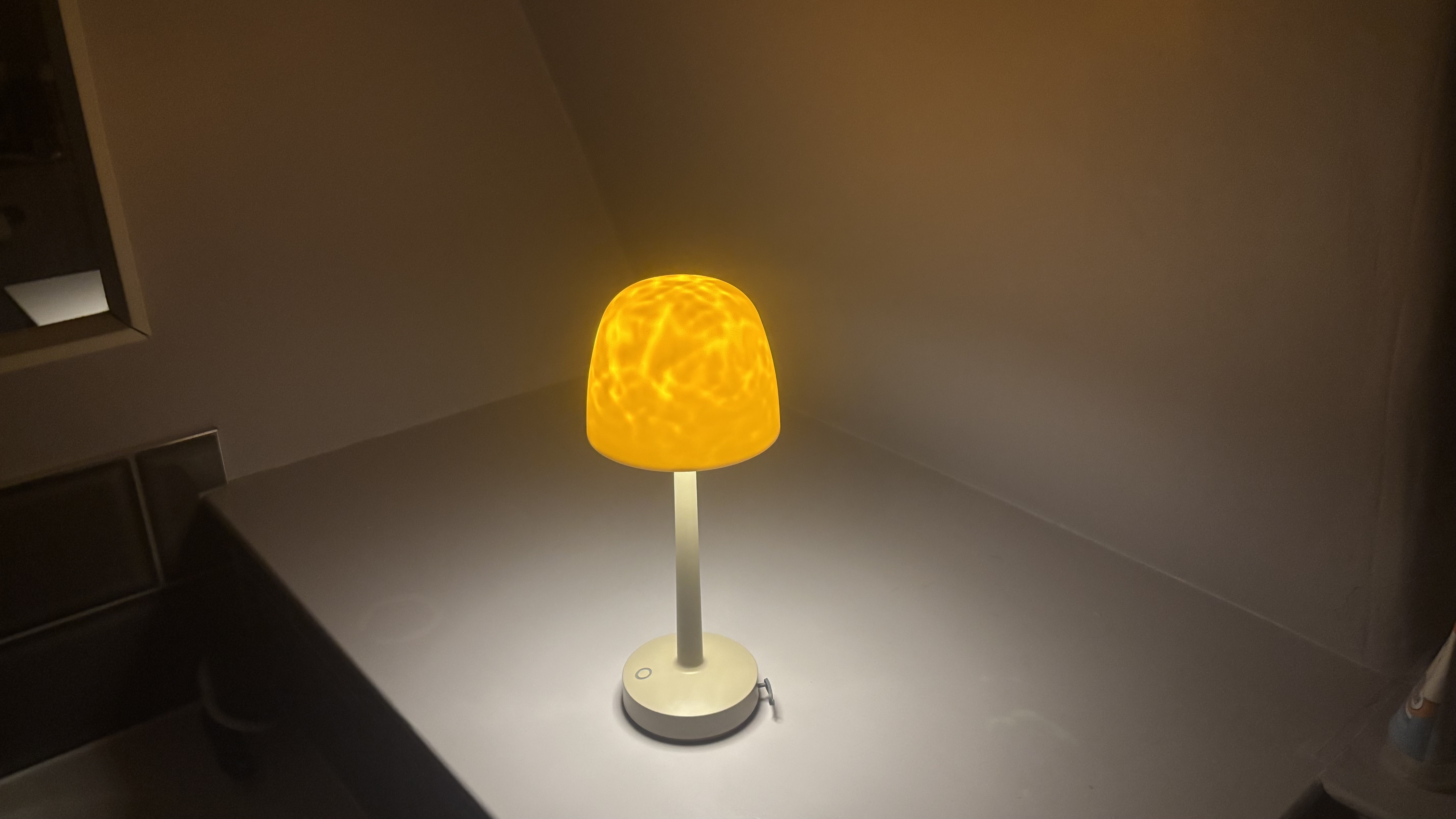 The Auria Glow Lamp in a dimly lit bathroom.