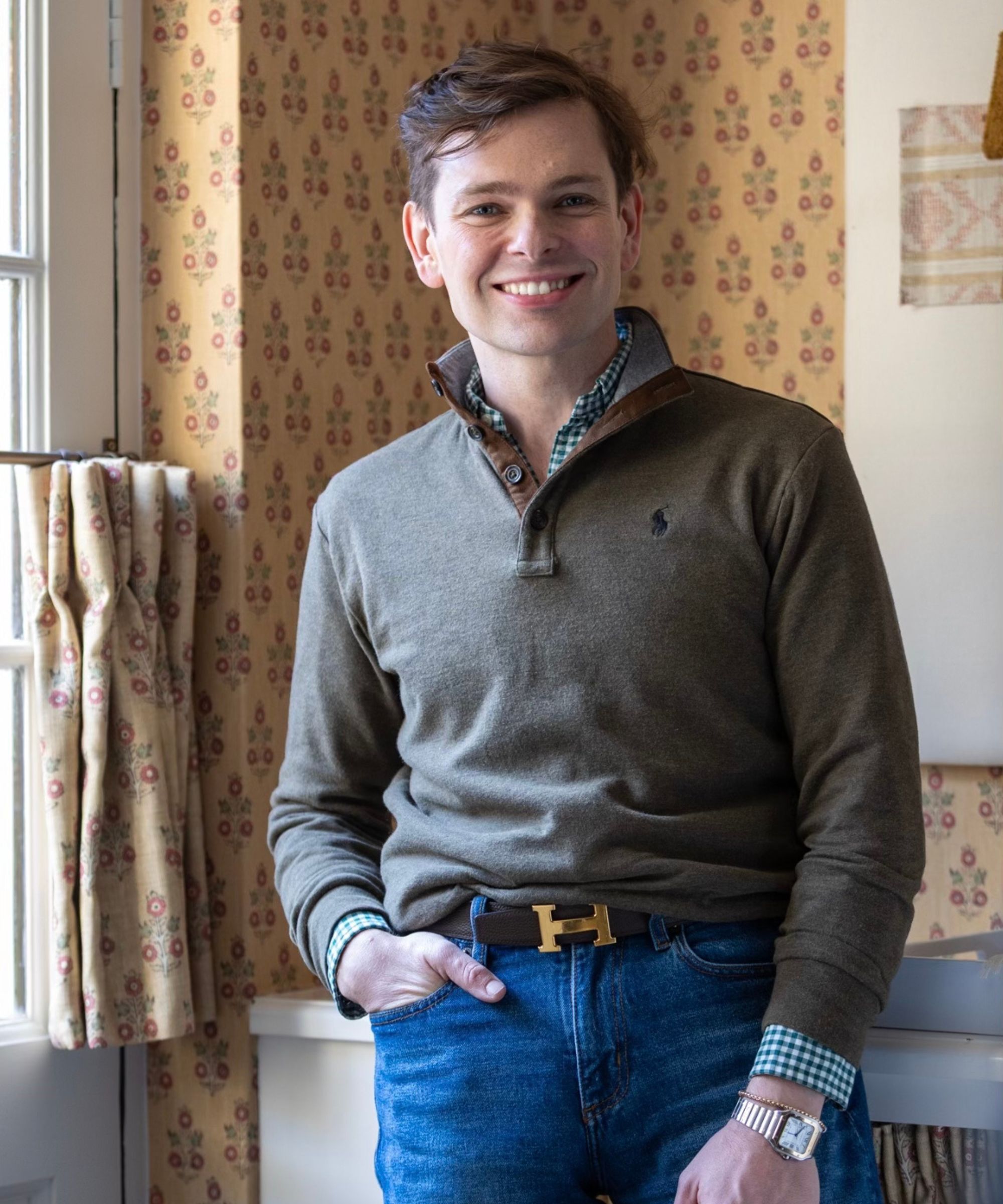 A man with a ralph lauren sweater and blue jeans