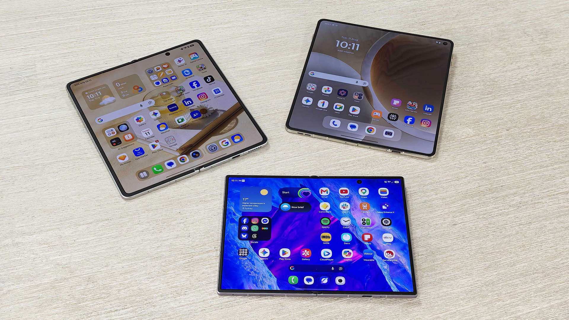 Three foldables, Samsung Galaxy Z Fold 8, Honor Magic V6 and Motorola Razr Fold on a desk.